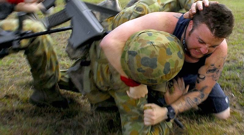 An Australian soldier strugles with a 'protester' on an exercise in Tin Can Bay. Photo by Corporal Chris Moore.