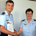 Leading Cadet Levi Schubert receives his Duke of Edinburgh’s International Award Bronze Award badge and certificate from the 6 Wing DEA Coordinator Flight Lieutenant (AAFC) Rae Nicholas.