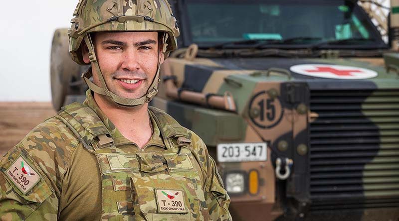 Australian Army soldier Corporal Levi Stripp is serving with Task Group Taji 4 at Taji Military Complex, Iraq, seen here with a Bushmaster Protected Mobility Vehicle - Ambulance. Photo by Corporal Kyle Jenner.