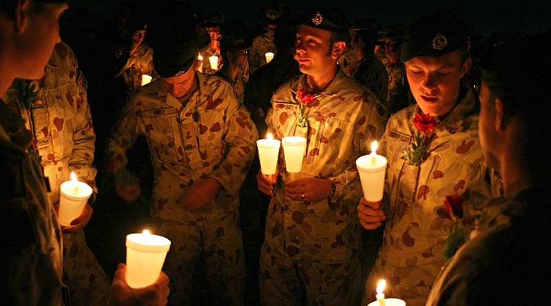 Members of Overwatch Battle Group–West get ready to participate in an ANZAC Day Dawn Service at Talil, Iraq, 2008. Photo by Brian Hartigan.