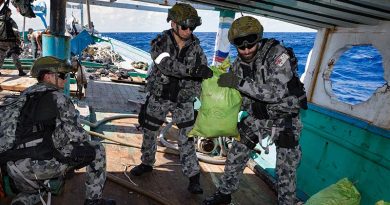 Members of HMAS Arunta's boarding party seize and account for illegal narcotics found during the search of a dhow while on patrol in the Middle East. Photo by Able Seaman Steven Thomson.