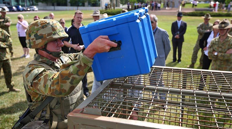 A soldier performs the box lift and place section of the physical employment standards assessment during a demonstration at Russell Offices in Canberra. Photo by Leading Seaman Paul Berry.