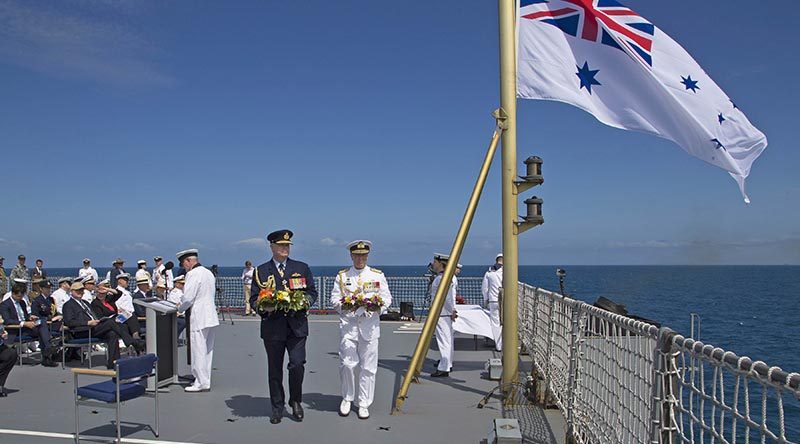 Chief of Defence Force Air Chief Marshal Mark Binskin and Chief of Navy Vice Admiral Tim Barrett carry wreaths to cast from the flight deck of HMAS Choules during the commemoration of the Battle of the Coral Sea. Photo by Able Seaman Richard Cordell.