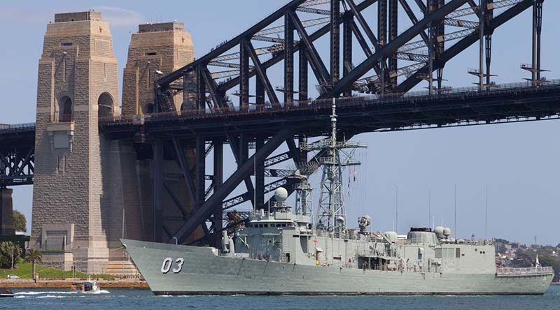 HMAS Sydney (IV) passes under the Sydney Harbour Bridge for the last time. Photo by Able Seaman Adam Porter.