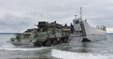 Army Corporal Robert Hosking drives a light armoured vehicle from a Navy landing craft. NZDF photo.