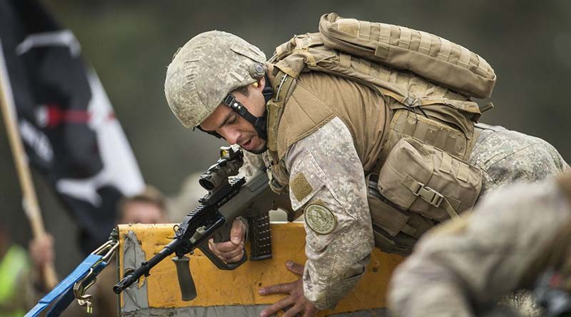 A New Zealand Army soldier clears the wall in an obstacle course match during the Australian Army Skill at Arms Meeting at Puckapunyal, Victoria. Photo by Sergeant Janine Fabre