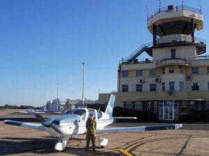 Cadet Corporal Courtney Semmler stands before the same control tower her great grandfather received instructions from 75 years earlier. Photo by Pilot Officer (AAFC) Paul Rosenzweig.