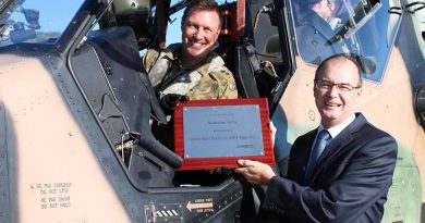 Lieutenant Colonel David Lynch, Commanding Officer School of Army Aviation, accepts a plaque to commemorate A38-001's world-first milestone on exceeding 2000 flight hours, from Managing Director Airbus Group Australia Pacific Tony Fraser. Airbus photo.