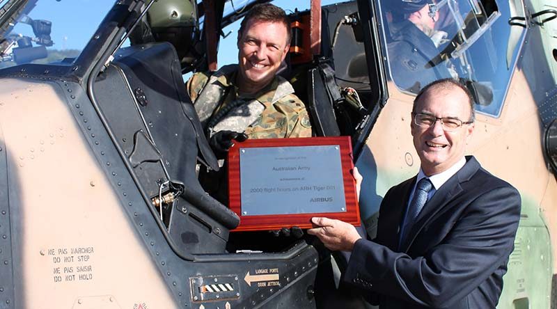 Lieutenant Colonel David Lynch, Commanding Officer School of Army Aviation, accepts a plaque to commemorate A38-001's world-first milestone on exceeding 2000 flight hours, from Managing Director Airbus Group Australia Pacific Tony Fraser. Airbus photo.