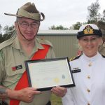 John Arnfield accepts a certificate of thanks for the Queensland National Serviceman’s Pipe Band from TS Koopa's Lieutenant Jane Reptik.