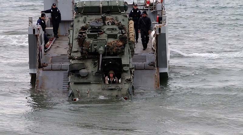 A LAV comes ashore from a landing craft during Exercise Joint Waka. Photo courtesy AirflowNZ.