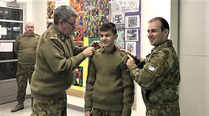 The Commanding Officer of 619 Squadron, Flying Officer (AAFC) Simon Blair presents rank slides to Cadet Adomas Neocleous as he is reclassified as a Leading Cadet. The CO is assisted by LAC(AAFC) Steve Stagbouer. Image supplied by No 619 Squadron