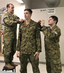 Commanding Officer 619 Squadron, Flying Officer (AAFC) Simon Blair promotes Cadet Corporal Nathan Richmond to Cadet Sergeant, assisted by Cadet Under Officer Lachlan Renfrey. Image supplied by No 619 Squadron