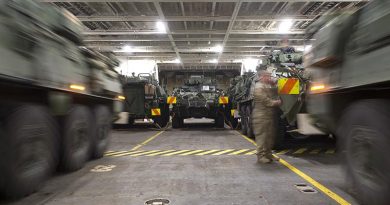 Two Light Armoured Vehicles (LAVs) are simultaneously driven into their parking spots onboard HMNZS Canterbury to be transported to Australia for Exercise Talisman Sabre.