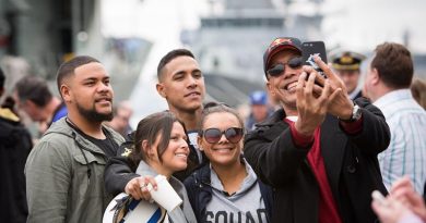 Family members pose for a selfie on the wharf at Fleet Base East before HMAS Newcastle departs for Operation Manitou. Photo by Able Seaman Bonny Gassner.