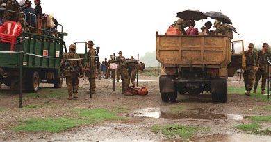 Soldiers operate a vehicle check point on a road in East Timor, 1999. Photo by Corporal Brian Hartigan.