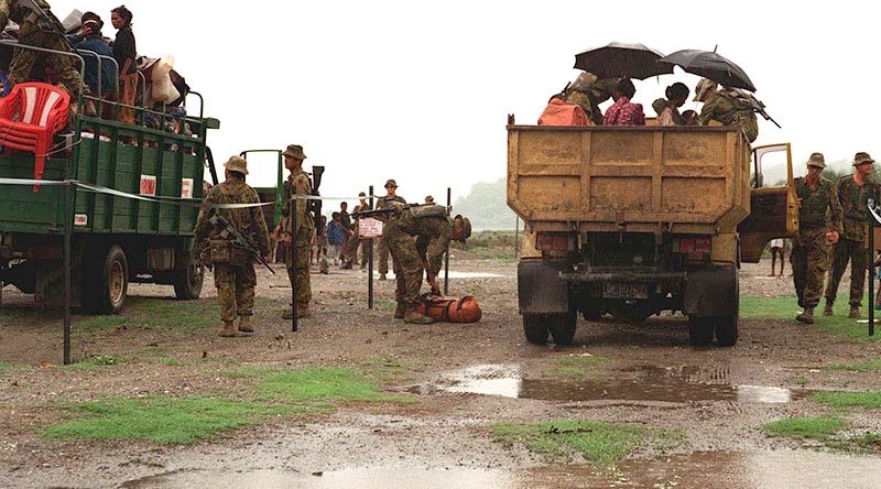 Soldiers operate a vehicle check point on a road in East Timor, 1999. Photo by Corporal Brian Hartigan.