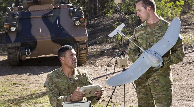 Corporal Matthew Molloy (left) and Corporal Doug Coombs from 2nd/14th Light Horse Regiment (Queensland Mounted Infantry) examine a Wasp unmanned aerial system. While the UAV (unmanned aerial vehicle) is one-man portable, the UAS (system) has a bit more weight to it. Photo by Sergeant Janine Fabre.