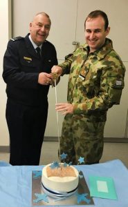 FLGOFF(AAFC) Simon Blair cuts his farewell cake with incoming Temporary Commanding Officer FLTLT(AAFC) James Roncoli. Image supplied by 619 Squadron AAFC