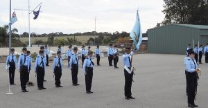 No 605 Squadron on parade at the Noarlunga Depot, with Cadet Under Officer Tahlia Sawtell as Parade Commander, Cadet Sergeant Christian Custodio (Banner Bearer) and Cadet Corporal Tanielle Edwards (Flight Commander), and the 6 Wing Band in the background. Image by Rick Fry.