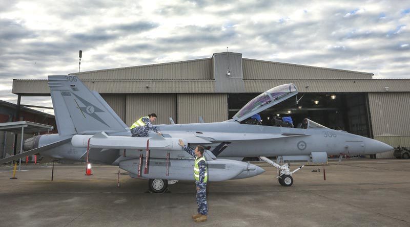 Leading Aircraftwoman Aimee-Rose Carter and Leading Aircraftman Fletcher Moulton perform routine checks on a newly arrived EA-18G Growler at No. 6 Squadron, RAAF Base Amberley. Photo by Corporal Brenton Kwaterski.