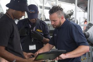 Shay from New Zealand Primary Industries works out a plan with Fijian Fisheries and Customs Officers during a fisheries patrol off Fiji. NZDF photo.