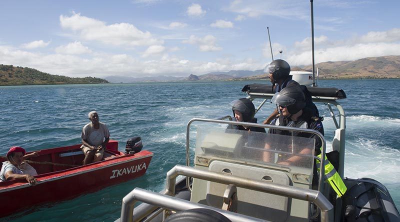 Fijian Fisheries Officer Waisea Aka speaks to a local fisherman during a HMNZS Hawea-assisted fisheries and customs patrol in Fiji. NZDF photo.