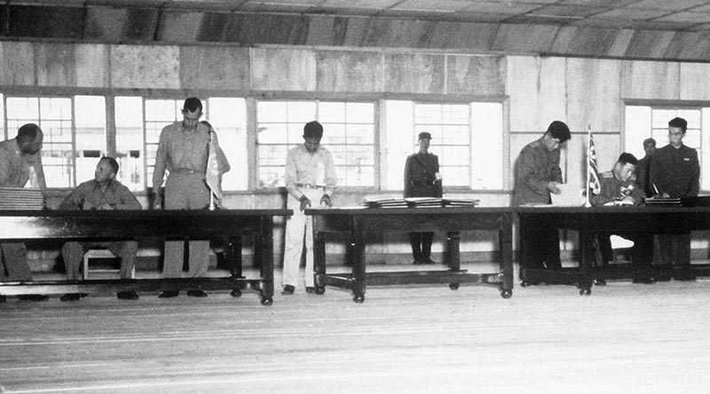 Delegates sign the Korean War Armistice on 27 July 1953. US DoD photo.