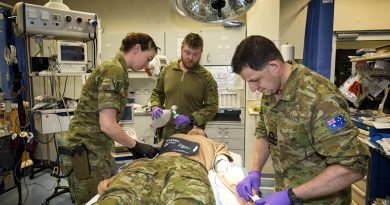 Task Group Afghanistan medics Flight Lieutenant Tessa O’Brien, Leading Seaman Peter Gough and Lieutenant Commander Gavin Milkins treat a simulated patient at the Role 2 Enhanced NATO Medical Treatment Facility at Hamid Karzai International Airport, Kabul, Afghanistan. Photo by Sergeant Ricky Fuller.