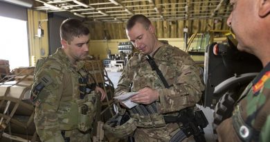 Armament Advisor to the Afghan Air Force Squadron Leader Nathan Gilmore (left) checks ammunition reserve levels with his colleagues at Hamid Karzai International Airport, Kabul, Afghanistan. Photo by Sergeant Ricky Fuller.