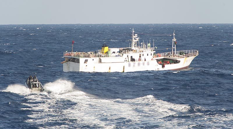 A Zodiac from HMNZS Otago, with fisheries officers from New Zealand and Vanuatu, approaches a fishing vessel in the south-west Pacific during Operation Island Chief. NZDF photo.