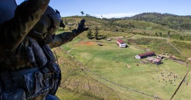 Australian Army soldier Corporal Rob Johnson, from the 5th Aviation Regiment in Townsville, waves to locals after conducting a community-engagement task during Operation Hannah in Papua New Guinea. Photo by Corporal Jake Sims.