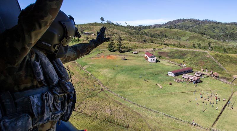 Australian Army soldier Corporal Rob Johnson, from the 5th Aviation Regiment in Townsville, waves to locals after conducting a community-engagement task during Operation Hannah in Papua New Guinea. Photo by Corporal Jake Sims.