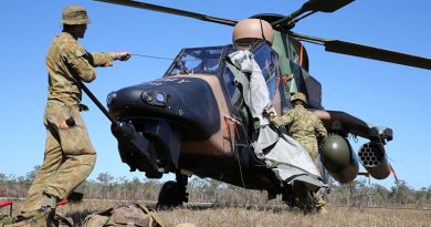 Craftsman Hayden Bermicham (left) and Craftsman Rhys Johannessen take the cover off a Tiger helicopter in preparation for pre-flight servicing at Shoalwater Bay Training Area during Exercise Talisman Saber 2013. Photo by Corporal Max Bree.