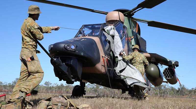 Craftsman Hayden Bermicham (left) and Craftsman Rhys Johannessen take the cover off a Tiger helicopter in preparation for pre-flight servicing at Shoalwater Bay Training Area during Exercise Talisman Saber 2013. Photo by Corporal Max Bree.