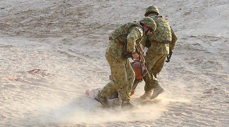 Soldiers rehearse a battlefield casualty evacuation in the Middle East. Photo by Brian Hartigan.