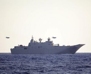 Two RAAF F/A-18 fighters fly past HMAS Adelaide during Indo Pacific Endeavour 17. Photo by Able Seaman Richard Cordell.