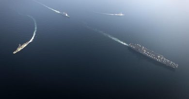 HMAS Newcastle (left) breaks formation with US aircraft carrier USS Nimitz, USS Princeton and France's FS Jean Bart. US Navy photo by Mass Communication Specialist Seaman Emily Johnston.