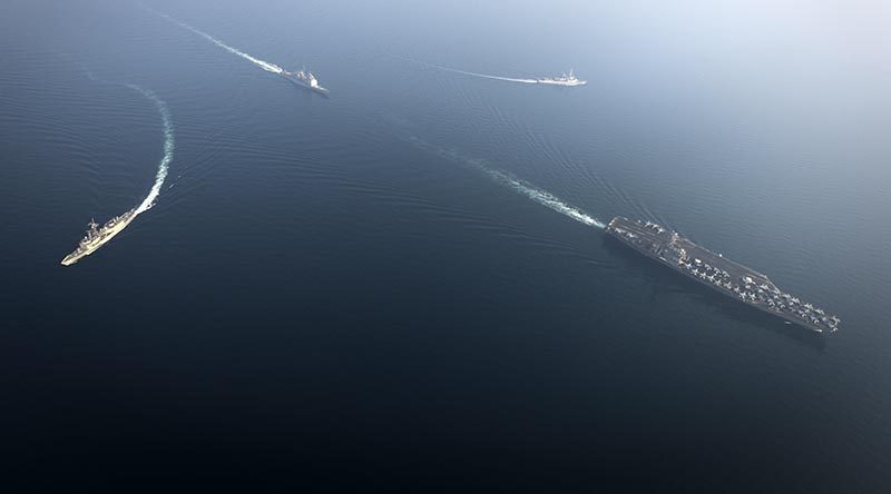 HMAS Newcastle (left) breaks formation with US aircraft carrier USS Nimitz, USS Princeton and France's FS Jean Bart. US Navy photo by Mass Communication Specialist Seaman Emily Johnston.