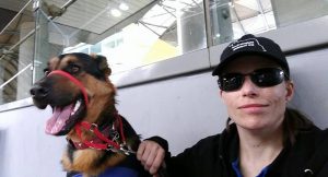 Melanie Scott and trainee Service Dog Paddington at the train station.