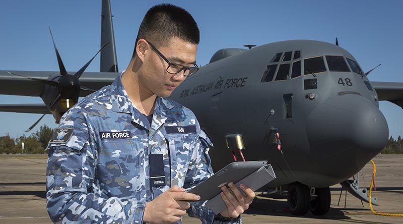 Flying Officer Josh Suh, Logistics Officer with Headquarters Air Mobility Group - Capability Development Cell, connects to the Ka-Band SATCOM during a technology-demonstrator trial. Photo by Corporal David Gibbs.