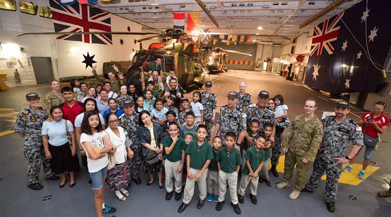 Crew from HMAS Adelaide pose with children and staff from the Amazing Grace Refuge Home, in Dinalupihan, Philippines during a visit to HMAS Adelaide while alongside in Subic Bay. Photo by Leading Seaman Peter Thompson.