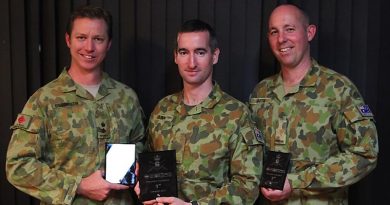 Lieutenant Colonel Glen Billington 19th Chief Engineer Works accepts 2nd prize on behalf of Major Tim Napper, winner Signaller Travis Quinn and 3rd place-getter Signaller James Martin, 7th Signal Regiment.