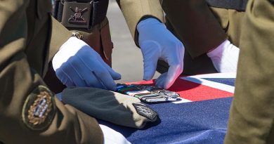 Colleagues of Sergeant Wayne Taylor place his beret and medals on his casket during a private service at Papakura Military Camp, Auckland, New Zealand. NZDF photo.