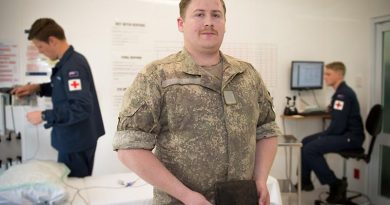 Private Hayden Cullen, New Zealand Army Band, holds a WWI wallet given to his grandfather by a German officer. NZDF photo.