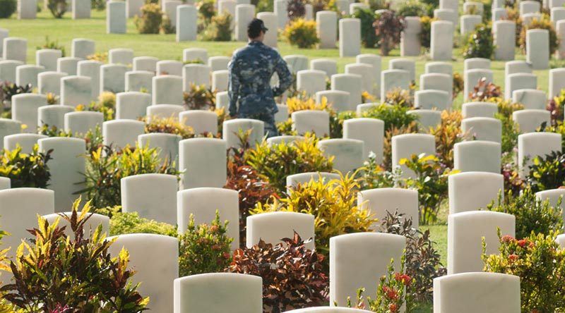 A RAAF member of the HMAS Adelaide crew walks through the headstones of Bomana Commonwealth War Cemetery, in Papua New Guinea, during Indo-Pacific Endeavour 2017. Photo by Private Roger Brennan.