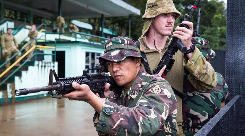 Philippine Army soldier Corporal Dennis Nalugon conducts urban-combat training with Australian soldier Lance Corporal Adam Seaman from the 3rd Brigade, at Capinpin, Philippines, as part of Operation Augury. Photo by Corporal Kyle Genner.