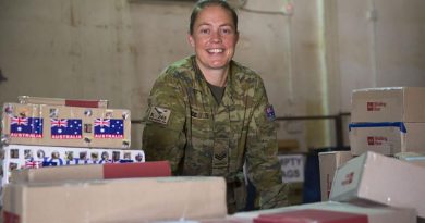 Task Group Taji postie Australian Army soldier Corporal Cassandra Rice is surrounded by work in the mail room at the Taji Military Complex, Iraq. Photo by Able Seaman Chris Beerens.