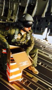 An un-named RAAF C-17 crew member prepares to drop a 'helibox' containing vital medical supplies. The boxes are designed to rotate enough to slow their decent. RAAF photo.