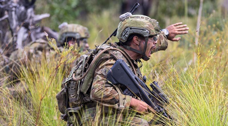 An Australian soldier from 8th/9th Battalion, Royal Australian Regiment, 'communicates effectively in a high-pressure tactical situation'. Photo by David Said.